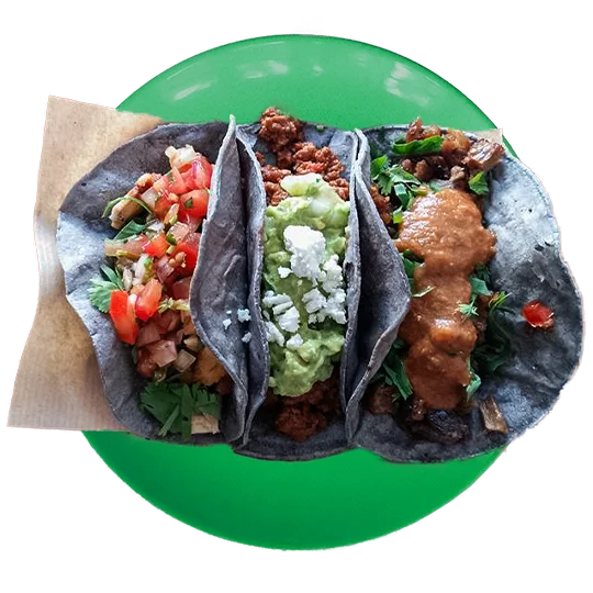 Tacos served on a bright green plate